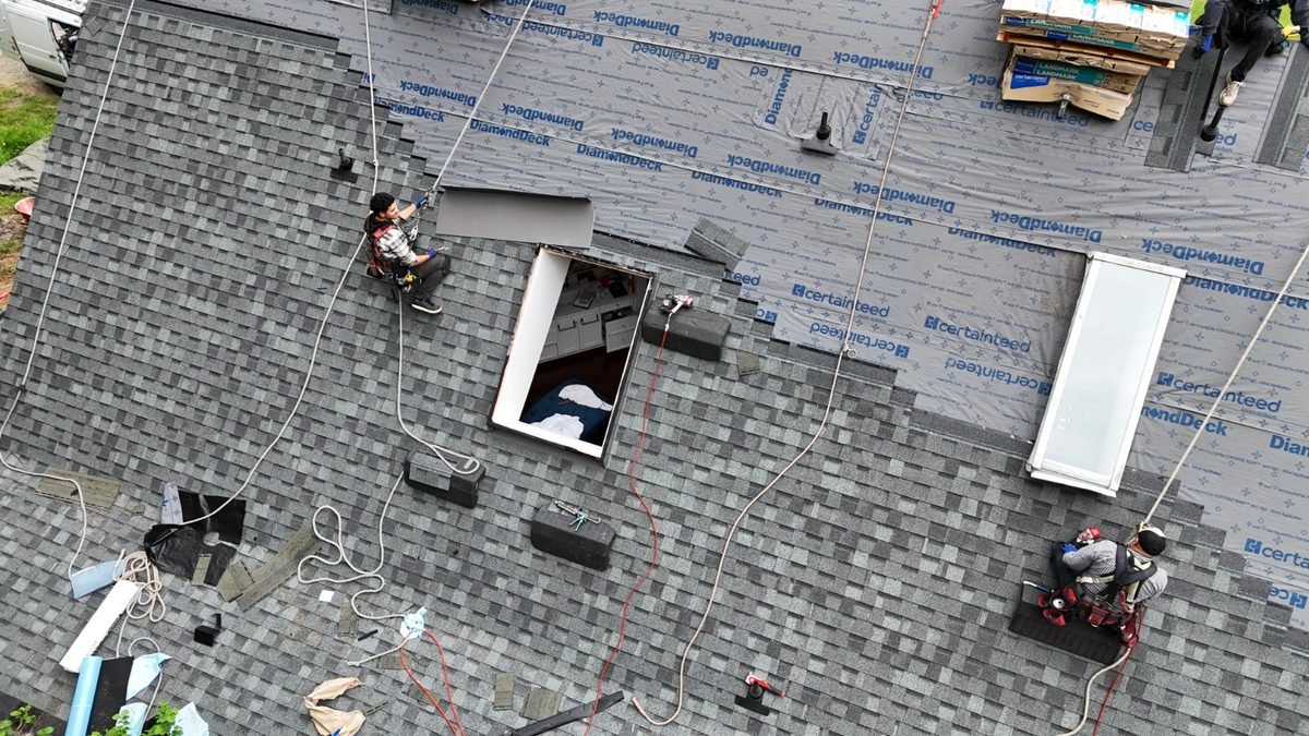 RR Roofing crew at work on a residential shingle roof