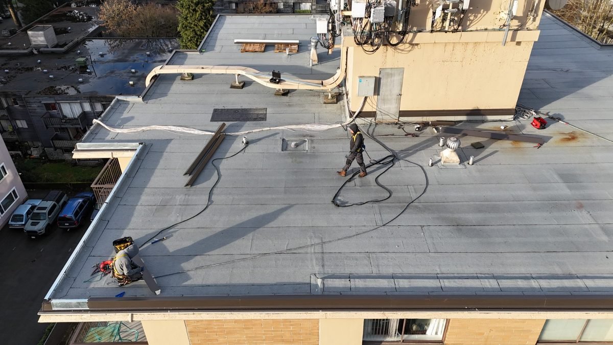 Torch-on flat roof installation in progress