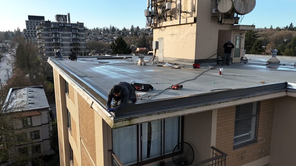 Torch-on work on a low-slope apartment roof