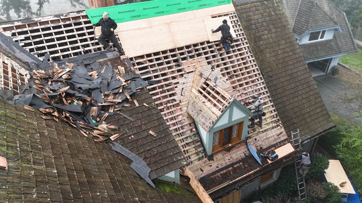 Full roof tear-off in progress with the decking exposed
