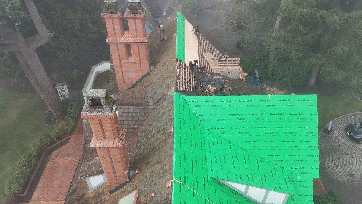 Aging shake roof at tear-off, showing years of wear